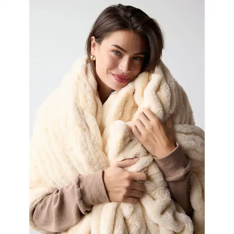 Luxurious faux fur blanket that brings relaxed warmth and cozy comfort to living areas.